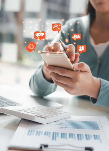 istock Young woman's hand is using a smartphone to play social media, a mobile phone with a notification icon,Social Distancing ,Working From Home concept. 1315302907