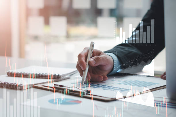 istock Business people or accountants are analyzing graphs on finance, investment, graph chart hologram in front, business strategy ideas, data analysis technology. 1315302993