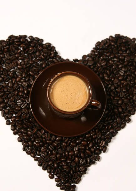 istock Coffee beans forming a heart. Cup of coffee 1315303808