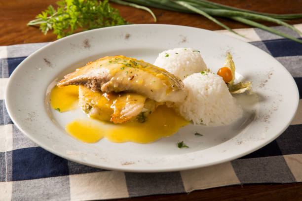istock fried tilapia served with rice on white plate. 1315304650