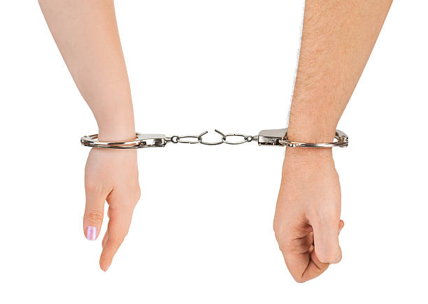 istock Man and woman hands with breaking handcuffs 131530581
