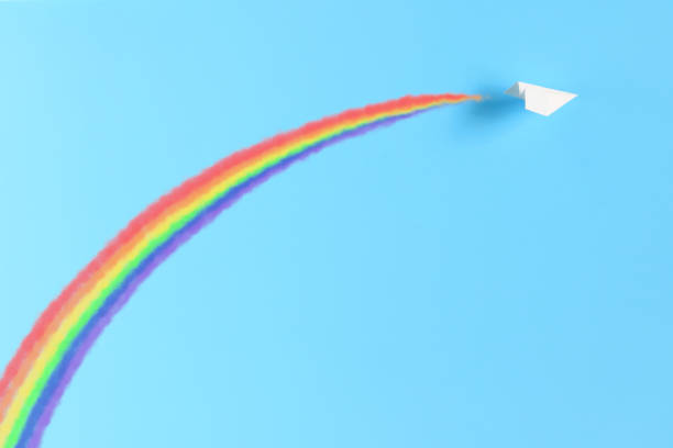 istock The paper plane making a rainbow with contrails. 1315309902