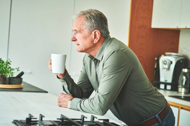 istock Shot of a senior man looking thoughtful while drinking coffee at home 1315315067
