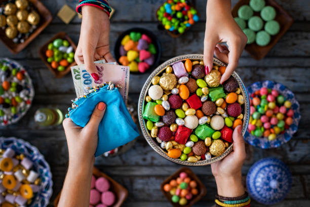 bowl of candies and chocolate at the hands of two women with tip. bayram and bahşiş concept. - chocolate coins imagens e fotografias de stock