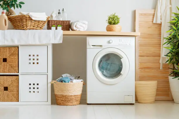 Interior of a real laundry room with a washing machine at home