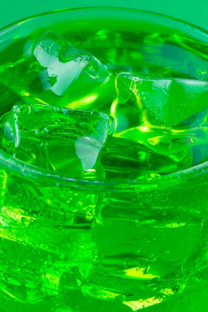 Closed up Ice cubes in green drink.