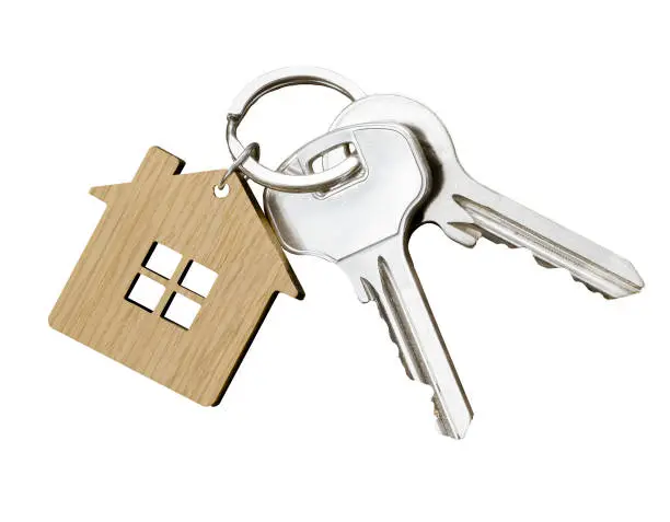 House key pair with house shaped keyring isolated on white background. Top view.