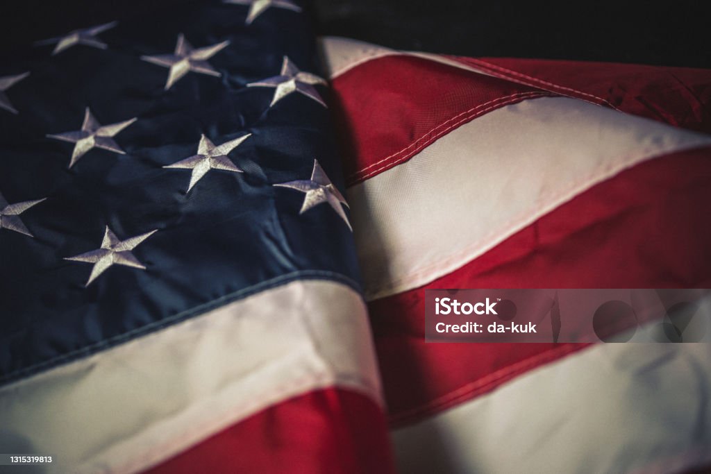 Flag of USA on dark background Flag of USA on dark concrete background.
Empty space provided for text placement for US celebrations such as: Memorial Day, Independence Day, etc. American Flag Stock Photo