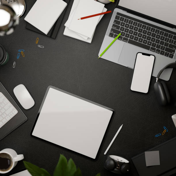 istock 3D rendering, dark creative flat lay workspace with tablet, smartphone, laptop, supplies and copy space on black table 1315319909