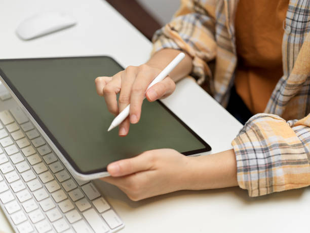 istock Side view of female freelancer working with digital tablet on computer table 1315319960