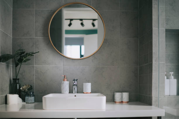interior of bathroom with mirror reflection and sink basin