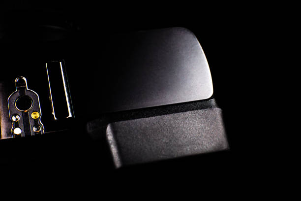 istock Black modern camera with lens on the black background. Close up. 1315325698