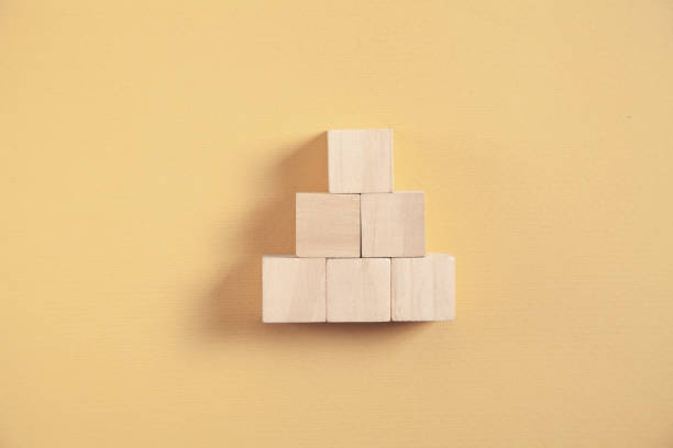 istock Wooden cubes on yellow background. 1315327016