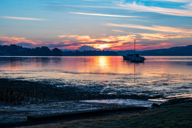 istock Sunrise waterscape with boats and soft colour 1315329115