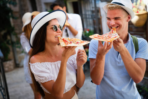 istock Group of friends eating pizza while traveling on vacation 1315329203