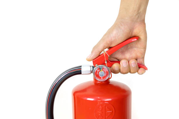 istock A man's hand holding a hand to catch fire extinguishers 1315330173