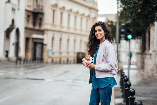 istock Beautiful woman having a coffee and breakfast on the move 1315333675