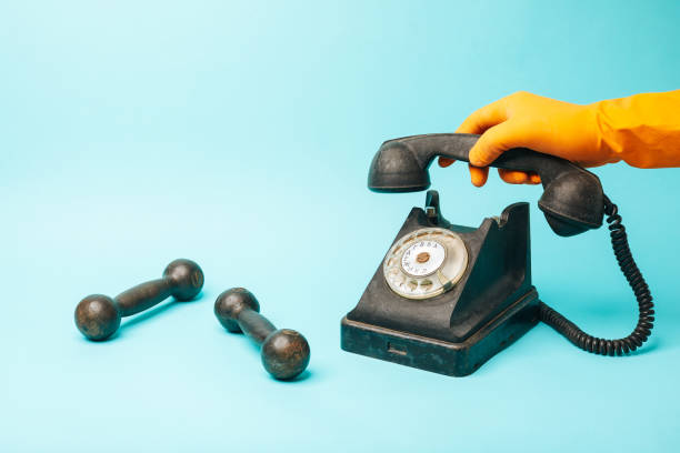 istock Vintage telephone and two dumbbells 1315335694