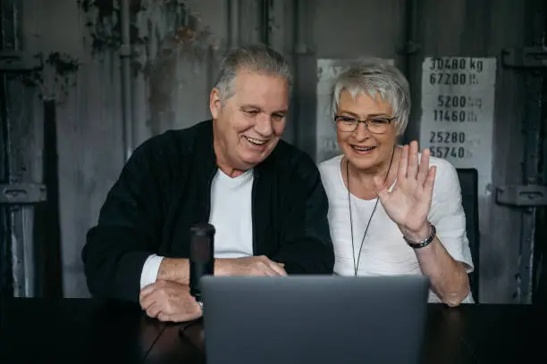 Grandparents talking via notebook to their grandchildren