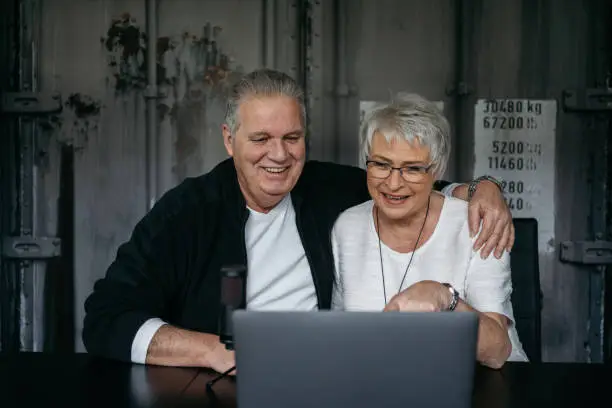 Grandparents talking via laptop to their grandchildren