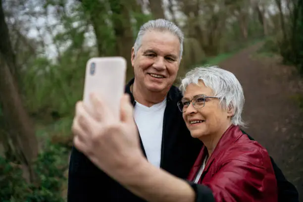 Elderly couple taking a selfie with their smartphone