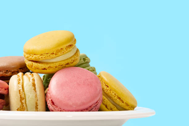 istock French dessert macaron isolated on blue background. Modern Macarons on colorful background. 1315338661