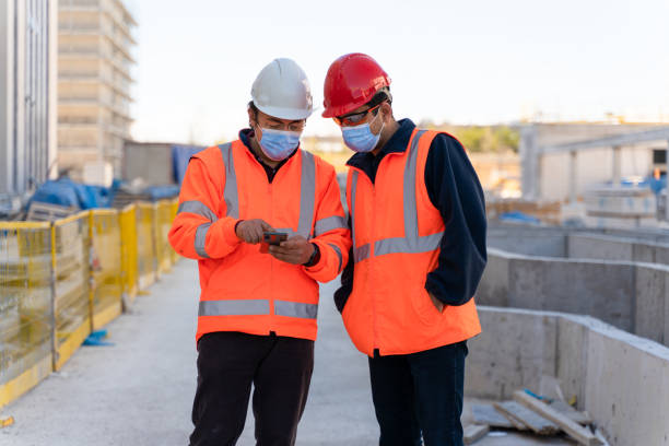 istock Engineers doing some examinations on the construction site on mobile phones 1315339551