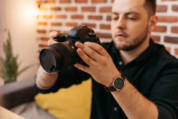 istock Man checking settings at his camera before the shooting at his own studio 1315340143