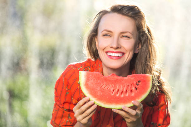 istock Beautiful woman eating watermelon 1315341425