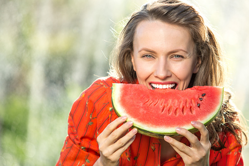 Beautiful woman eating watermelon