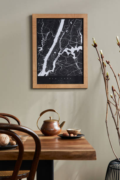 istock Stylish dining room interior with mock up poster map, wooden walnut table, design chairs, cup of coffee, decoration, tableware and elegant personal accessories in home decor. Template. 1315344260
