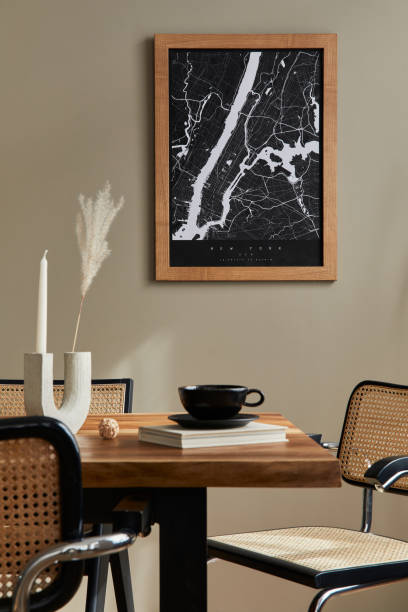 istock Stylish dining room interior with mock up poster map, wooden walnut table, design chairs, cup of coffee, decoration, tableware and elegant personal accessories in home decor. Template. 1315344266