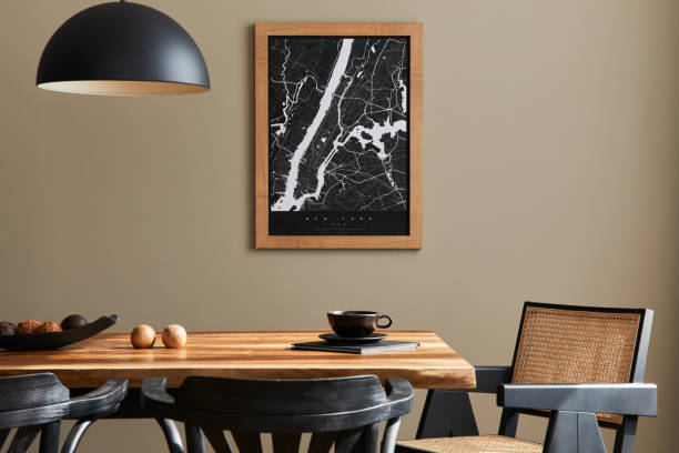 istock Stylish dining room interior with mock up poster map, wooden walnut table, design chairs, cup of coffee, decoration, tableware and elegant personal accessories in home decor. Template. 1315344273