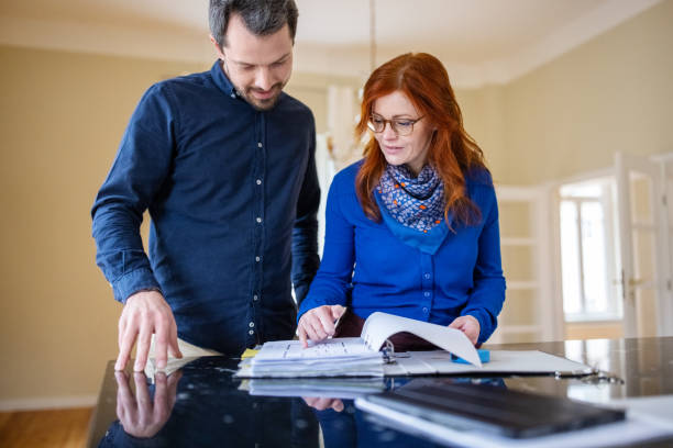 istock Couple planning over blueprint at kitchen island 1315344297