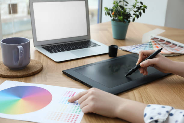 istock Professional designer with graphic tablet at wooden table, closeup 1315345099