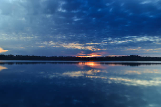 istock Sunset sky background. Dramatic gold sunset with evening sky clouds over the lake. Stunning sky clouds in the sunrise. Sky landscape. Panoramic view. Summer landscape 1315349898