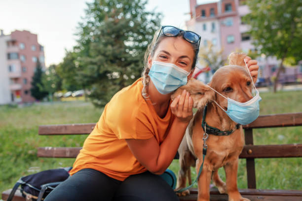 istock Woman and her dog with protective face mask 1315352020