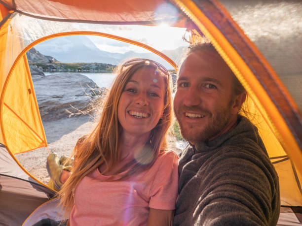 istock Couple take selfie inside a tent, camping weekend 1315352191
