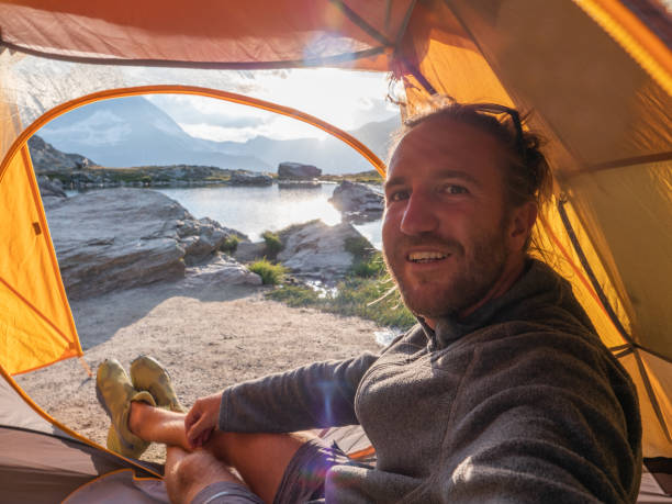 istock Man takes selfie inside tent, camping fun 1315352721