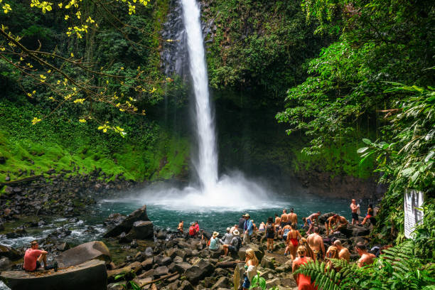 Tourists and locals visiting the La Fortuna waterfall in Costa Rica stock photo