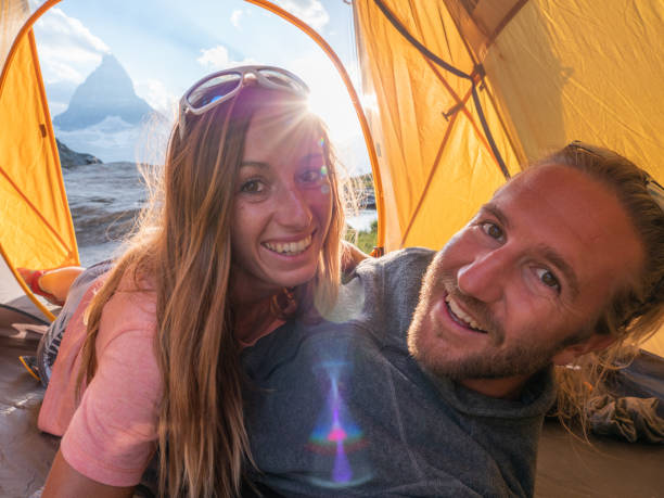 istock Couple take selfie inside a tent, camping weekend 1315354117