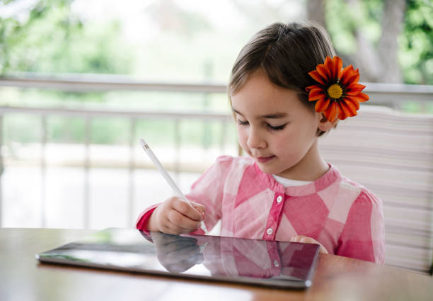 istock Child Girl Drawing Pictures Using Digital Tablet 1315356546