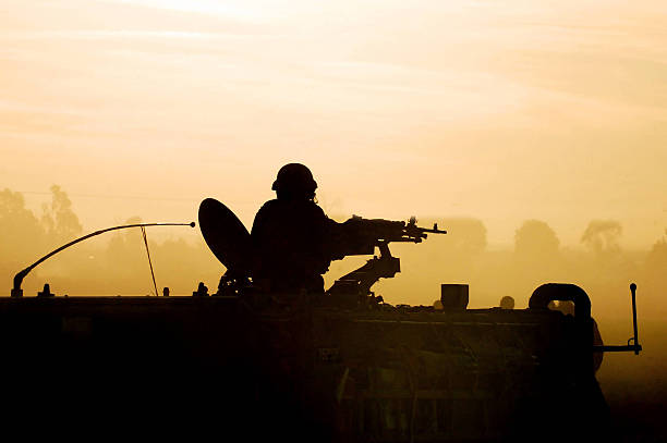 Silhouette Army Soldier Sunset Silhouette of an army soldier preparing his tank and weapons at sunset gaza strip photos stock pictures, royalty-free photos & images