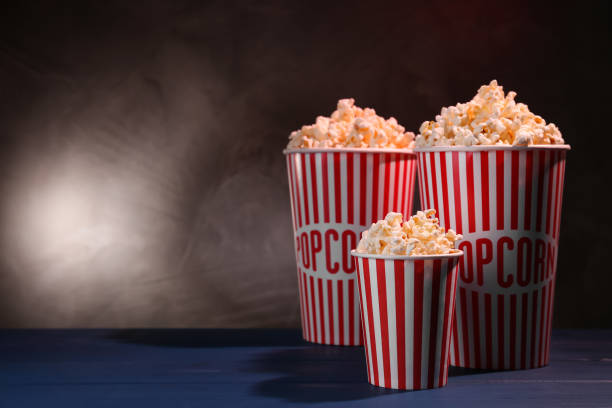istock Delicious popcorn on blue wooden table. Space for text 1315357594
