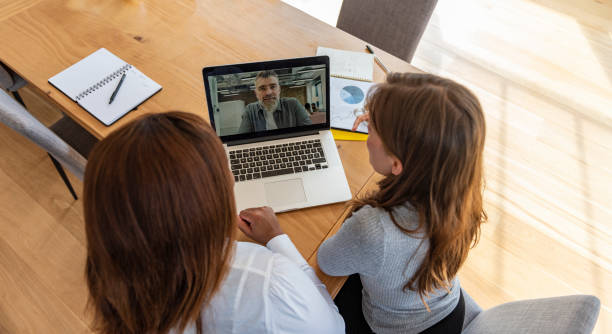 istock Colleagues video chatting with superior 1315358497