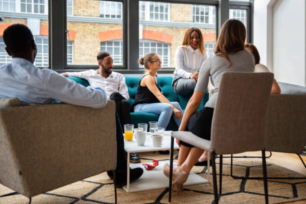 istock Coworkers taking a break in office lounge. Office break room 1315358539