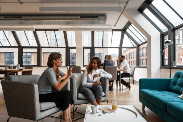 istock Coworkers taking a break in office lounge. Office break room 1315358565