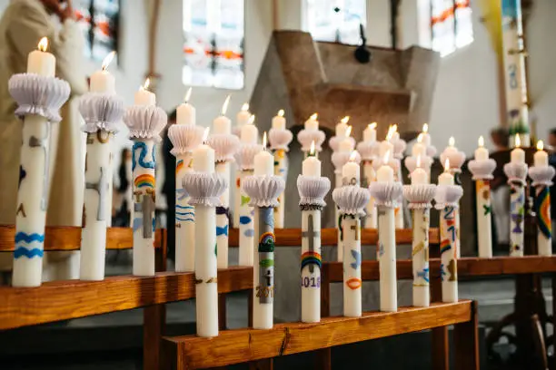 Communion candles in front of an altar at a catholic church