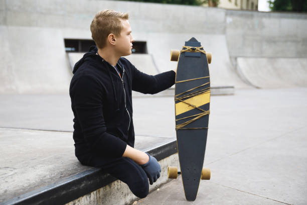 istock Young handicapped guy with a longboard in a skatepark 1315360255