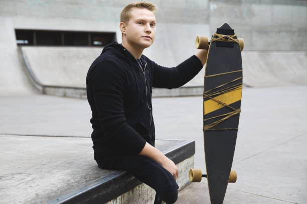 istock Young handicapped guy with a longboard in a skatepark 1315360429